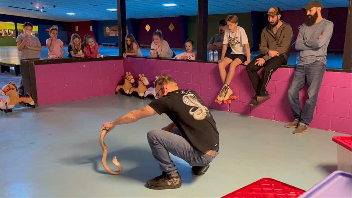 Joey demostrating Lilith the cobra.